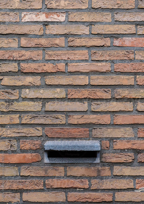 Brick wall with a mail box.