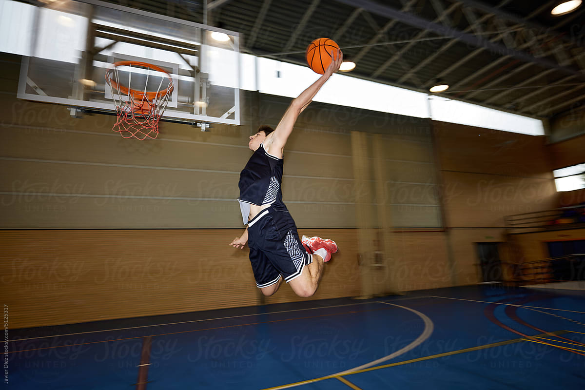 Basketball player throwing ball into hoop
