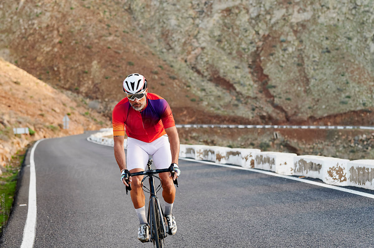 Fit mature man riding up a mountain road