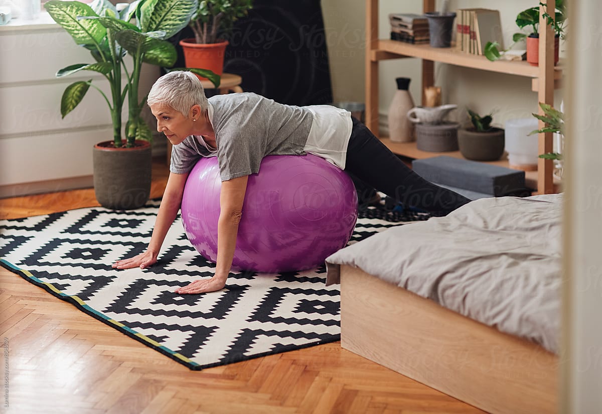 Woman exercising with a fit ball at Home