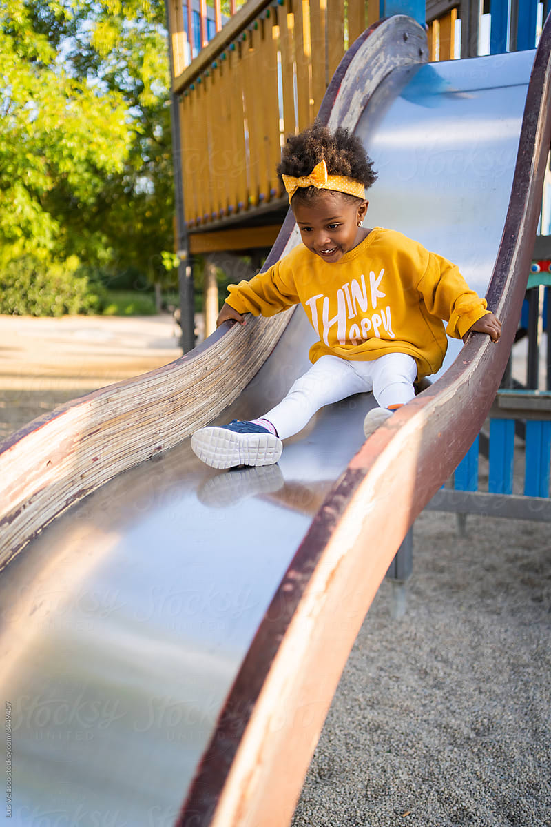 Little Black Girl In The Slide Of The Play Area.