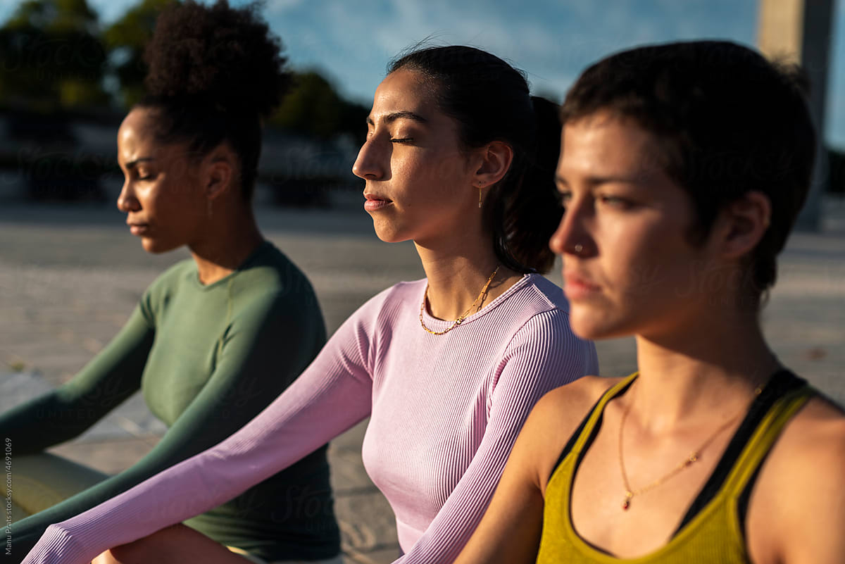 Multiracial women meditating