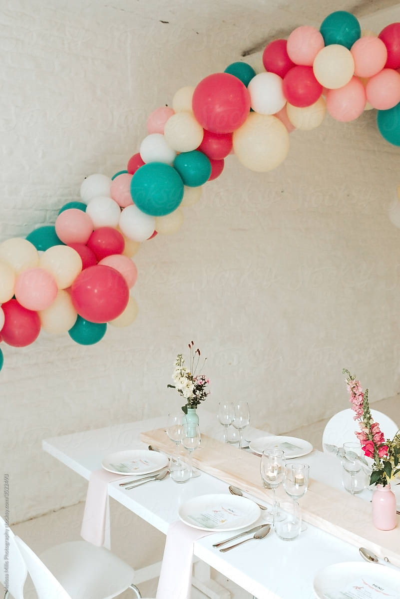 Wedding table with balloon arch in pastel colored theme