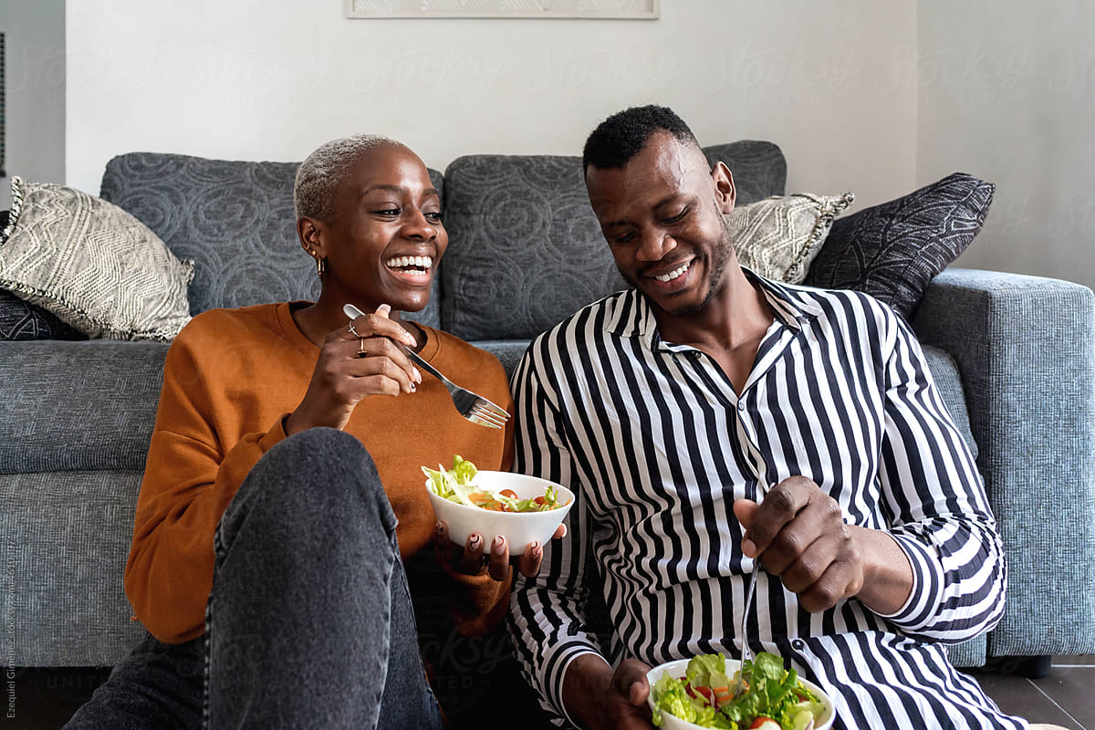 Beloved black couple having lunch in living room