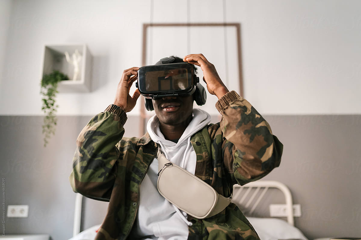 Black gamer putting on VR headset