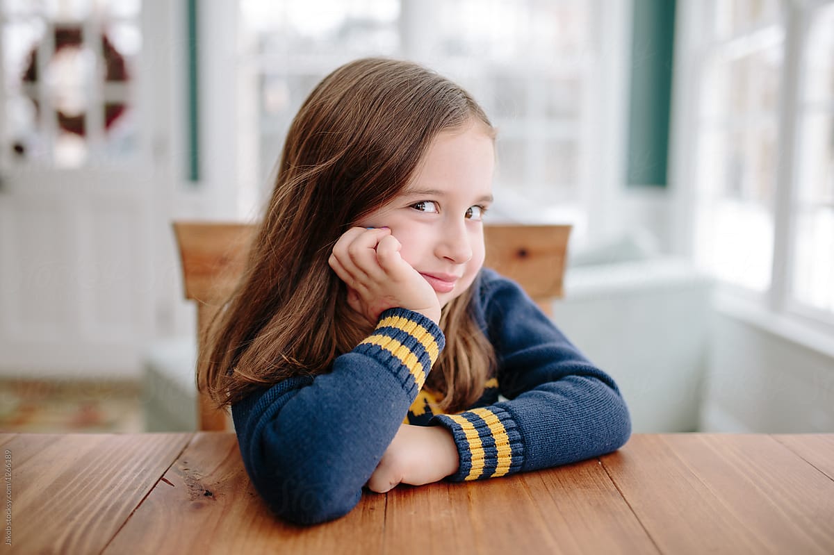 Cute Young Girl Smiling At Table By Stocksy Contributor Jakob 1213