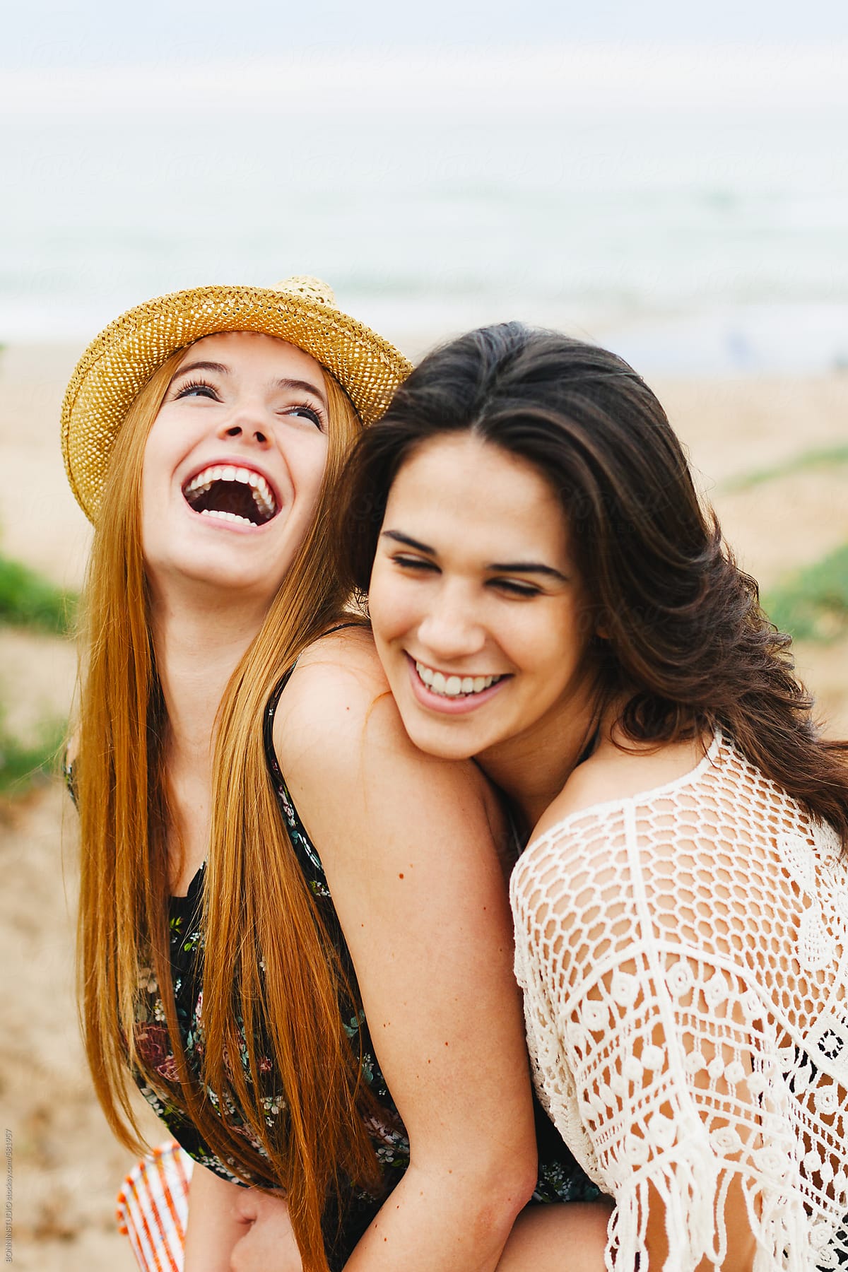 Portrait Of Two Young Female Friends Having Fun On The Beach Del Colaborador De Stocksy 