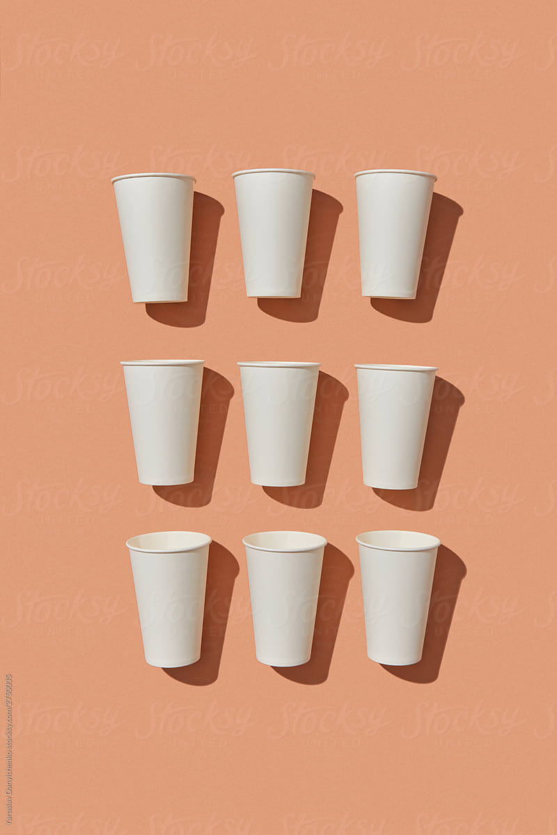 White paper cups with shadows.
