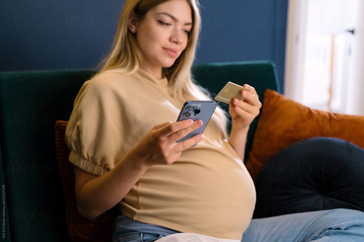 Cheerful Pregnant Woman Paying For Online Order With A Card
