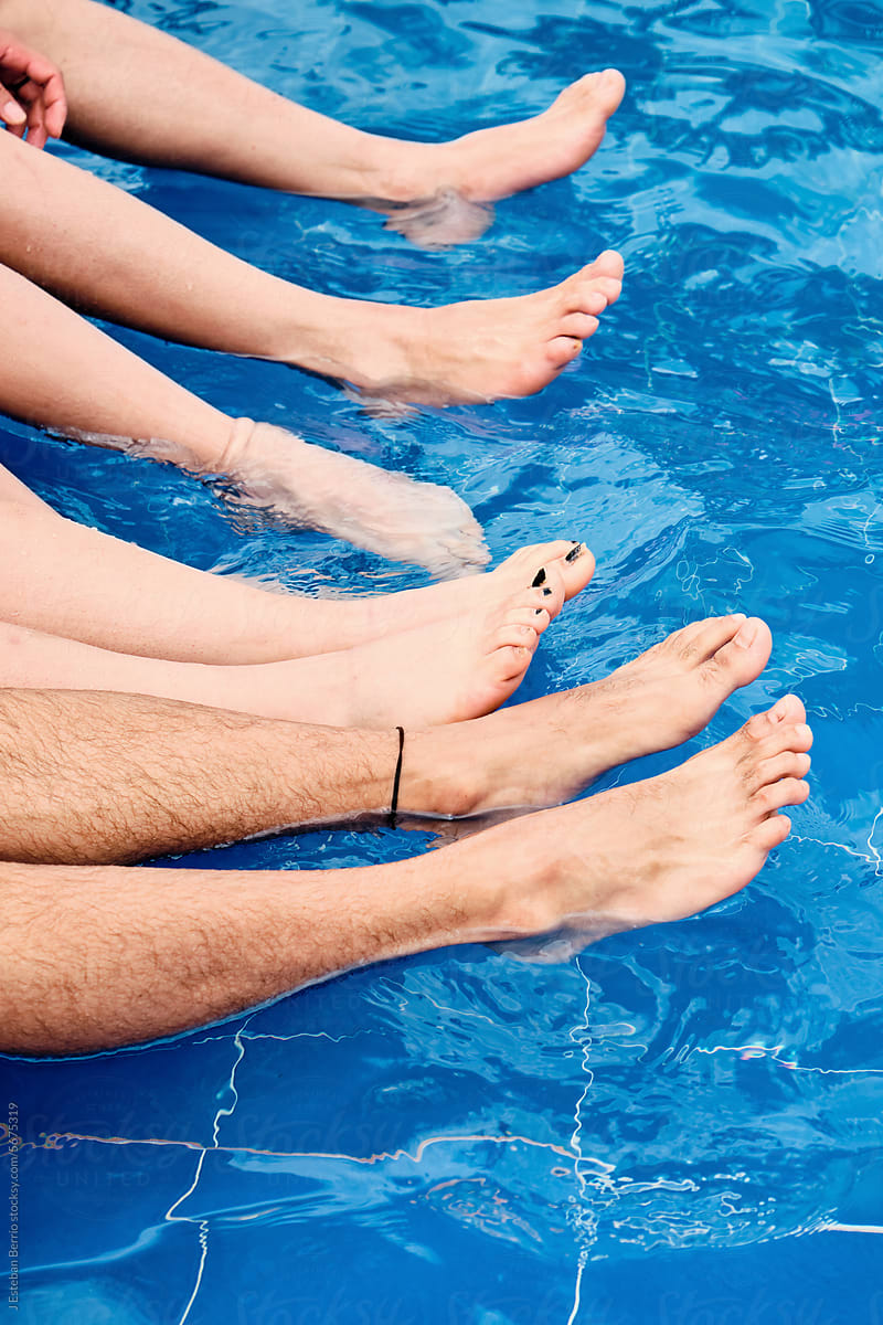 Best friends with their feet in the pool