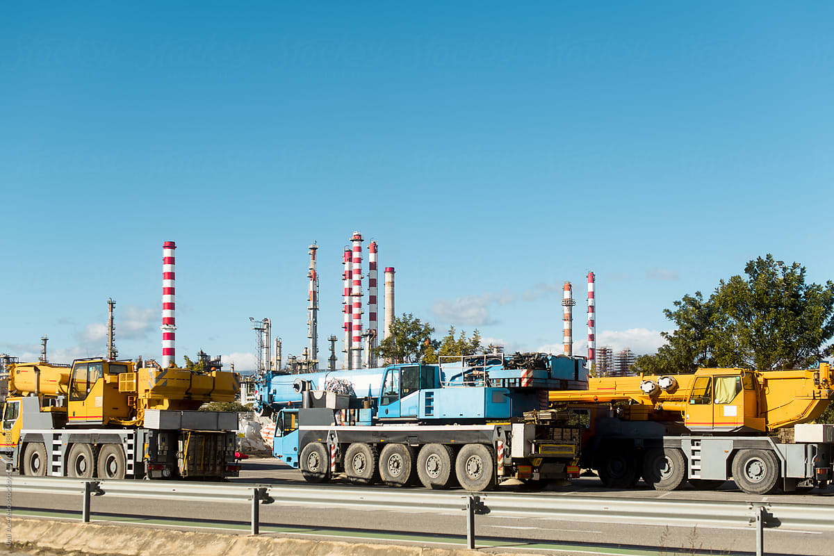 Heavy crane trucks with factory as background