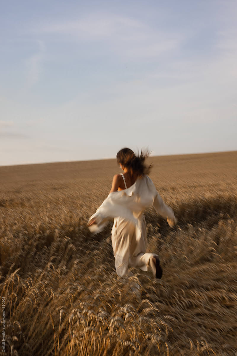 Woman in loungewear running on meadow