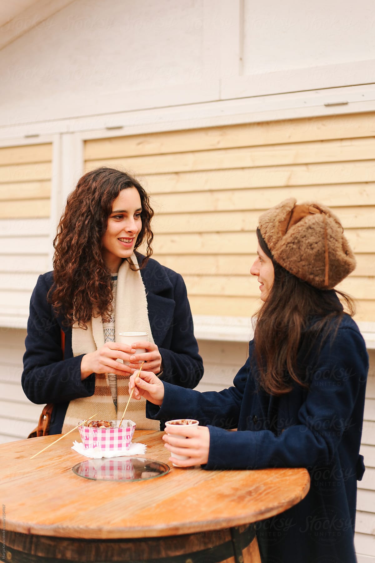 Two Women Drinking Coffee Outdoor By Stocksy Contributor Marija Kovac Stocksy