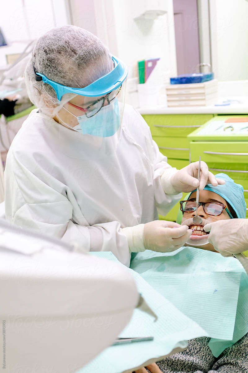 Dentist checking teeth of patient