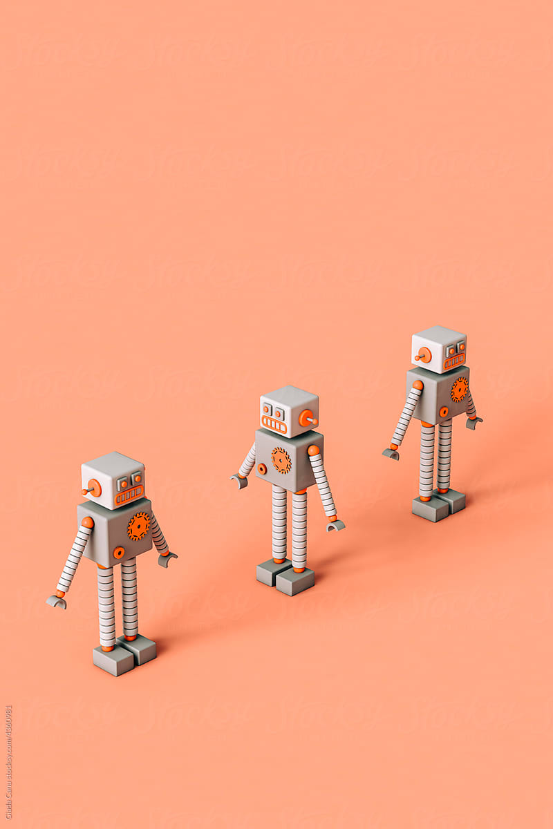 three Toy robots on a pink background