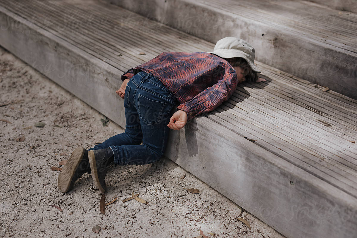 Child lying on step