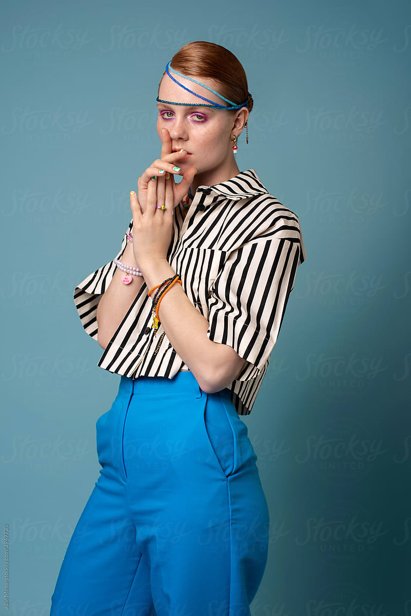Portrait of a girl in a striped shirt and bright outfit