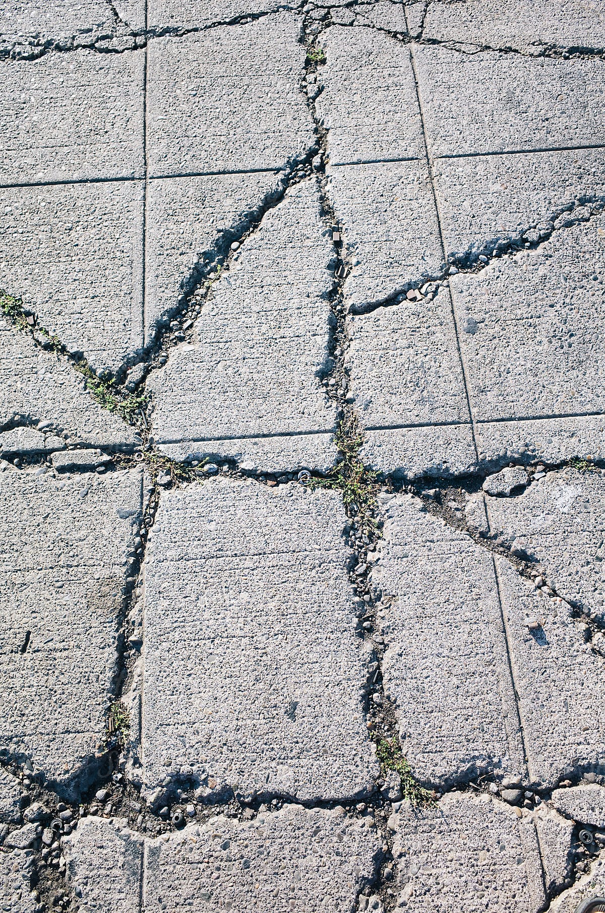 Detail of cracked and worn urban sidewalk
