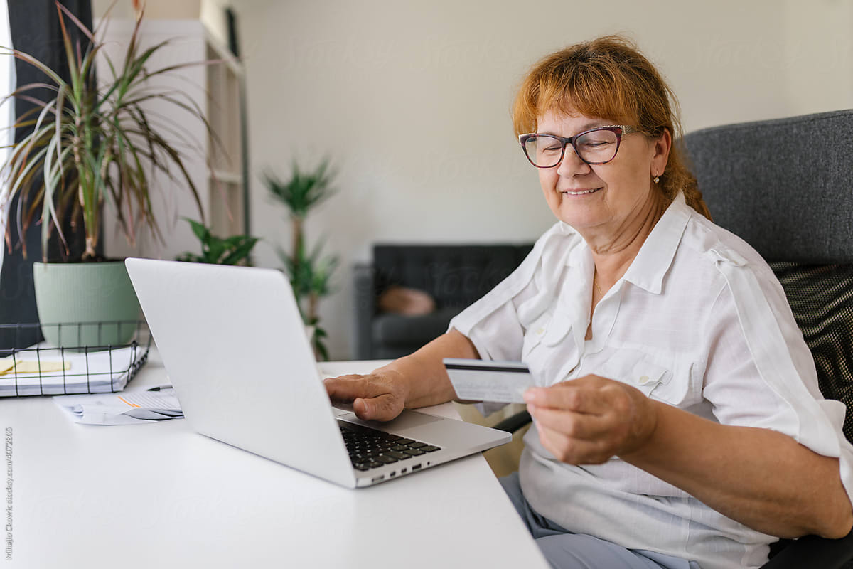 Senior woman using credit card for online payment