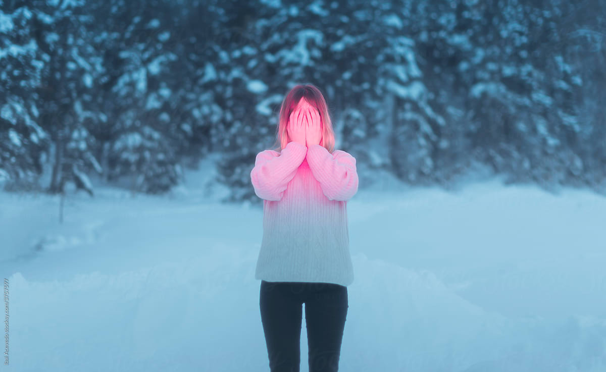 Anonymous woman covering her face on the snow