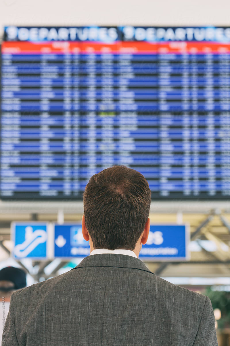 Airport: Anonymous Man Looking At Departure Board