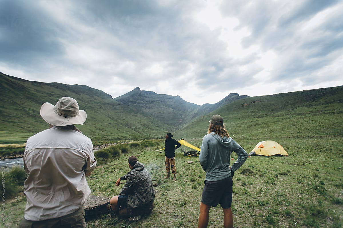hikers enjoying the view from their camp in the mountains