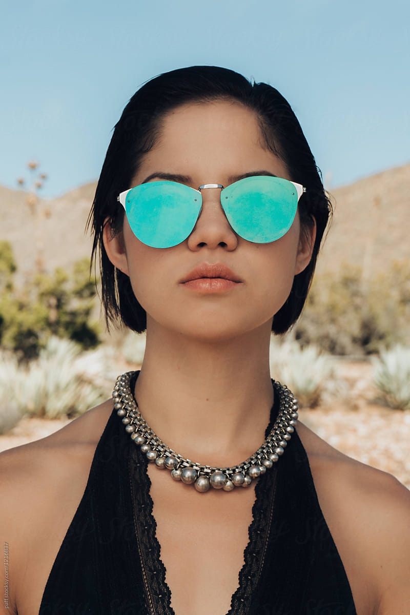 Fashion model in the desert with jewelry and sunglasses