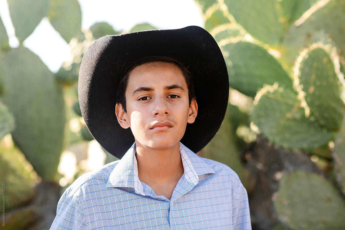 Teen Cowboy by Cactus Trees