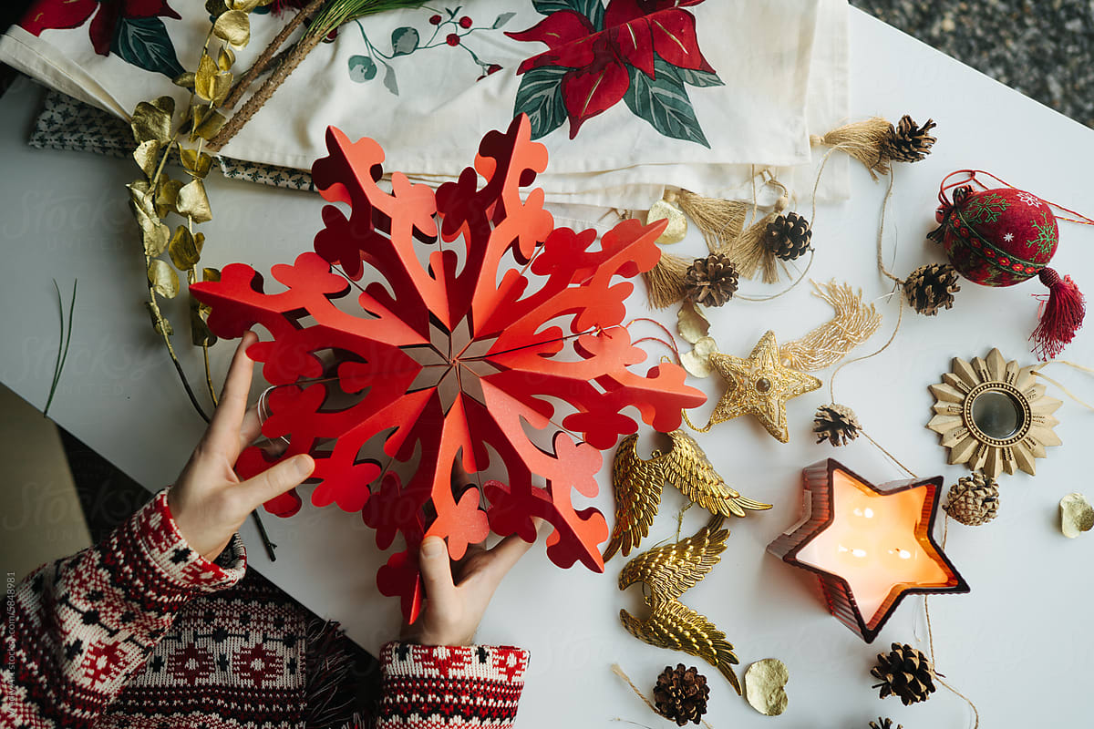 Unrecognizable person arranging handmade Christmas decorations
