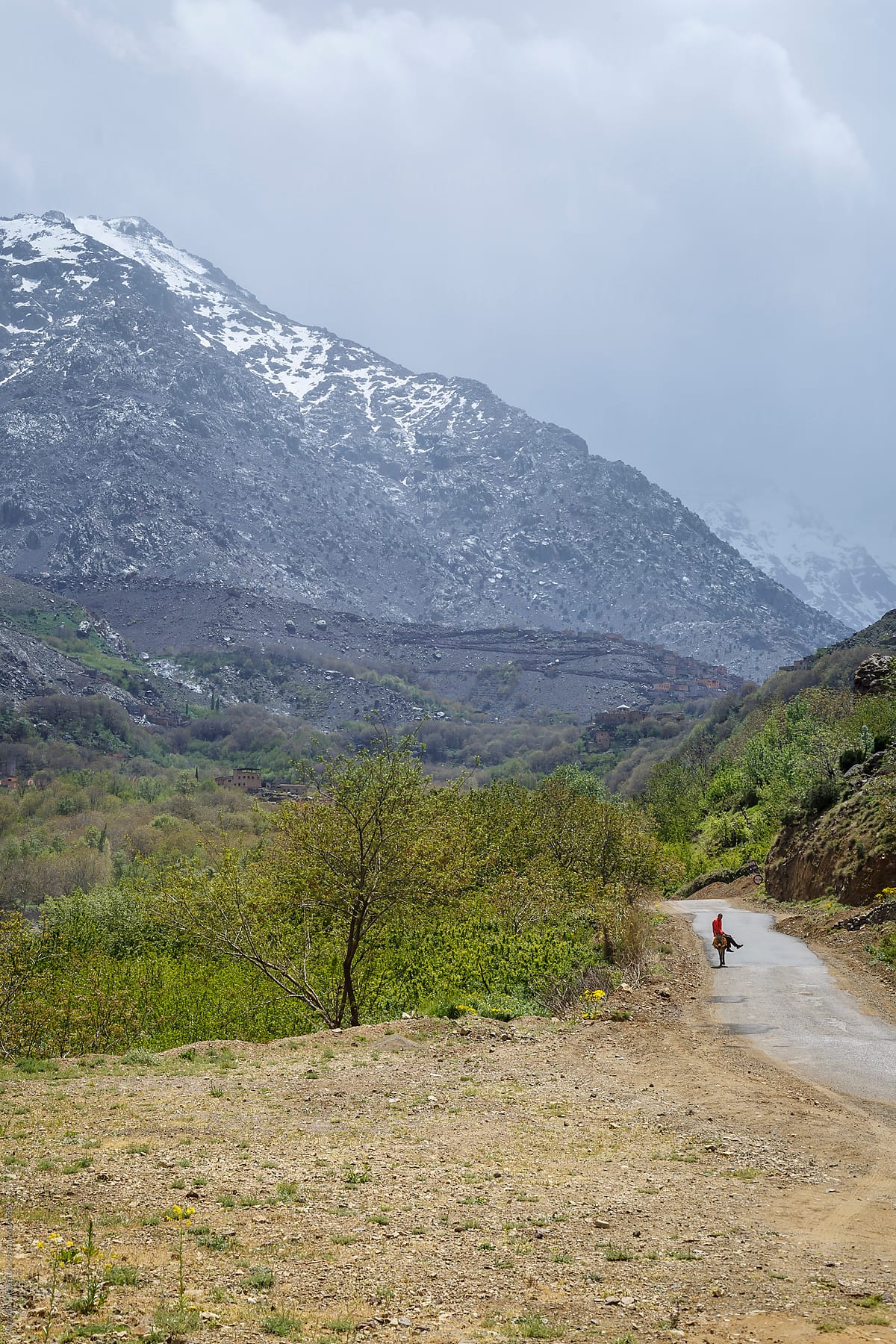 Man riding a donkey on a mountain path