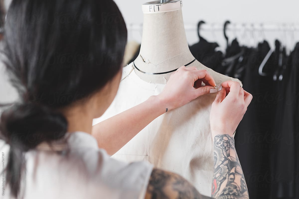 Young Female Fashion Designer Working on a Mannequin