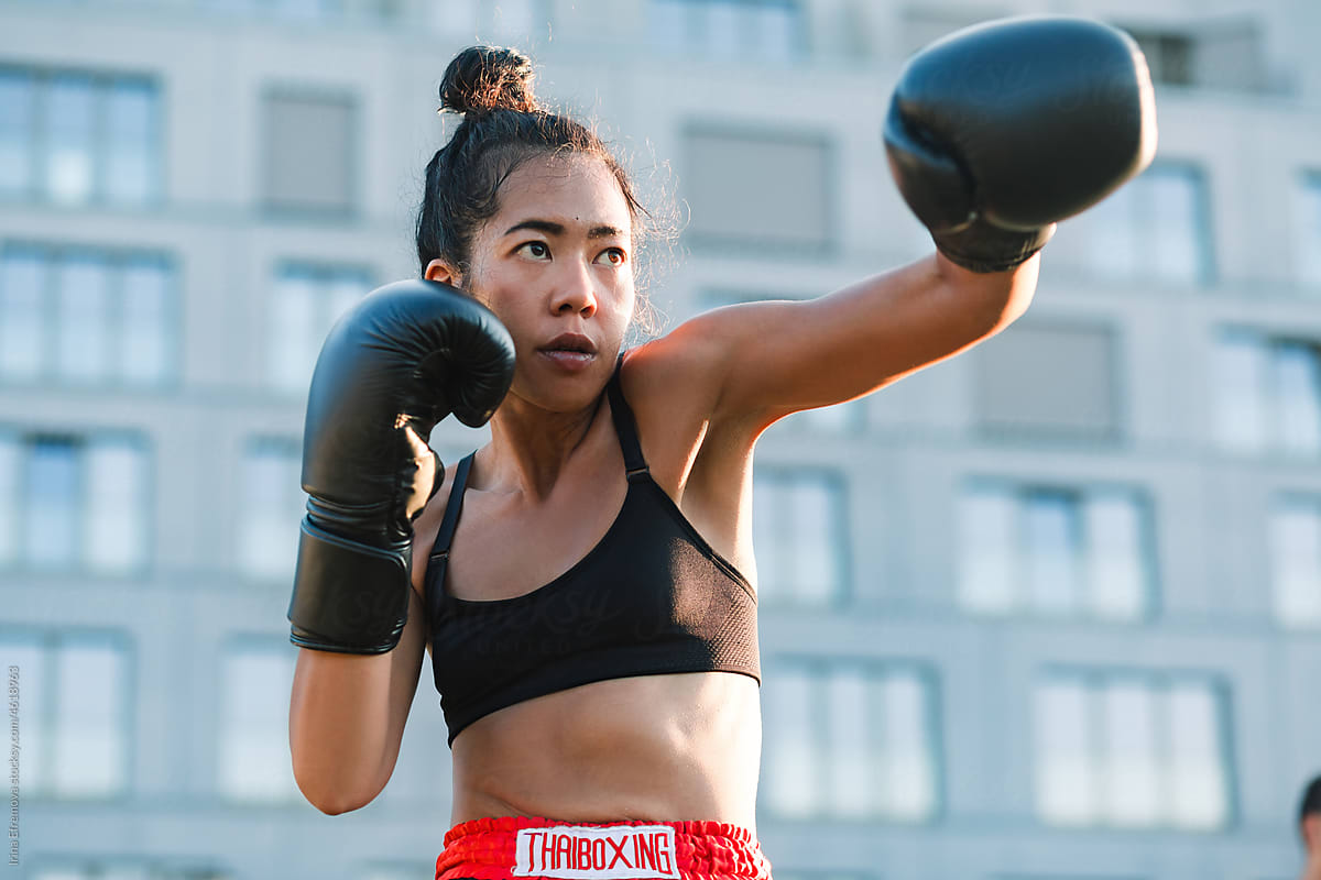 Female Boxer Practicing Punches Outdoors