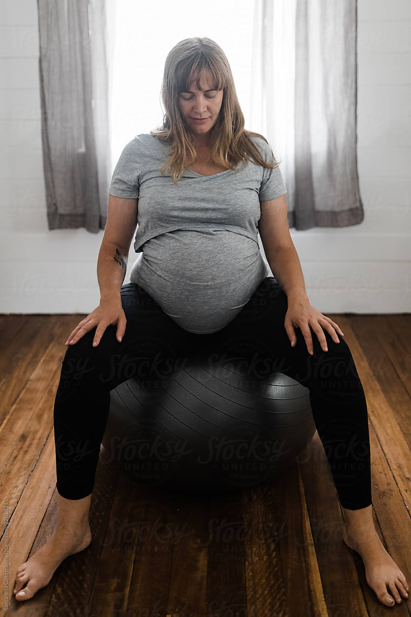 full term pregnant woman on exercise ball