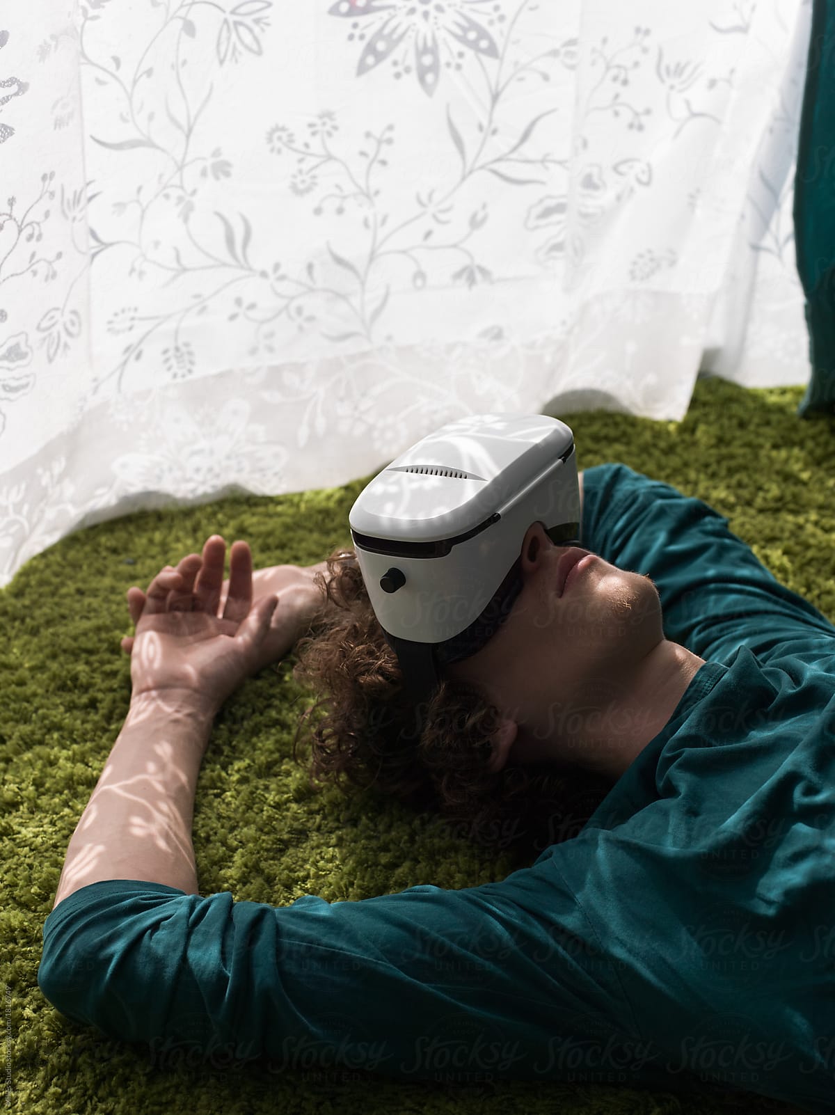 Man lying on carpet in VR glasses