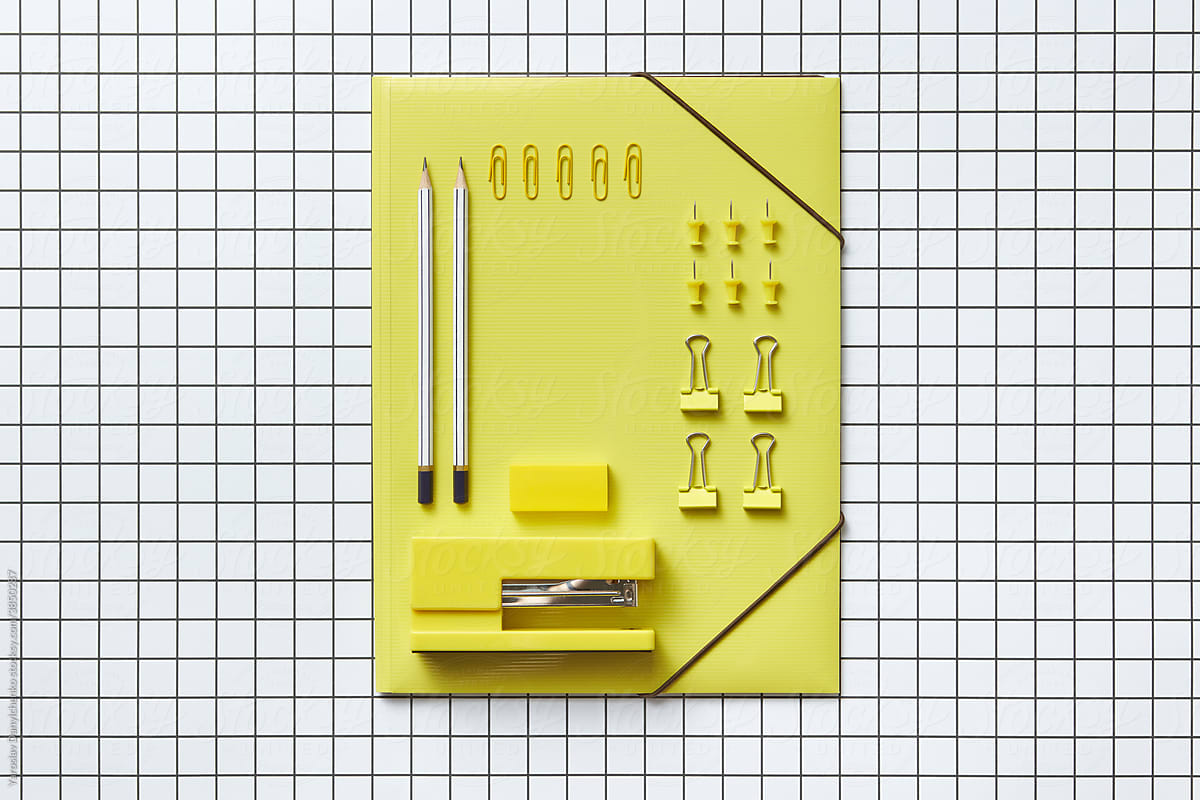 Yellow folder, paper clips, pins, stapler, eraser and pencils