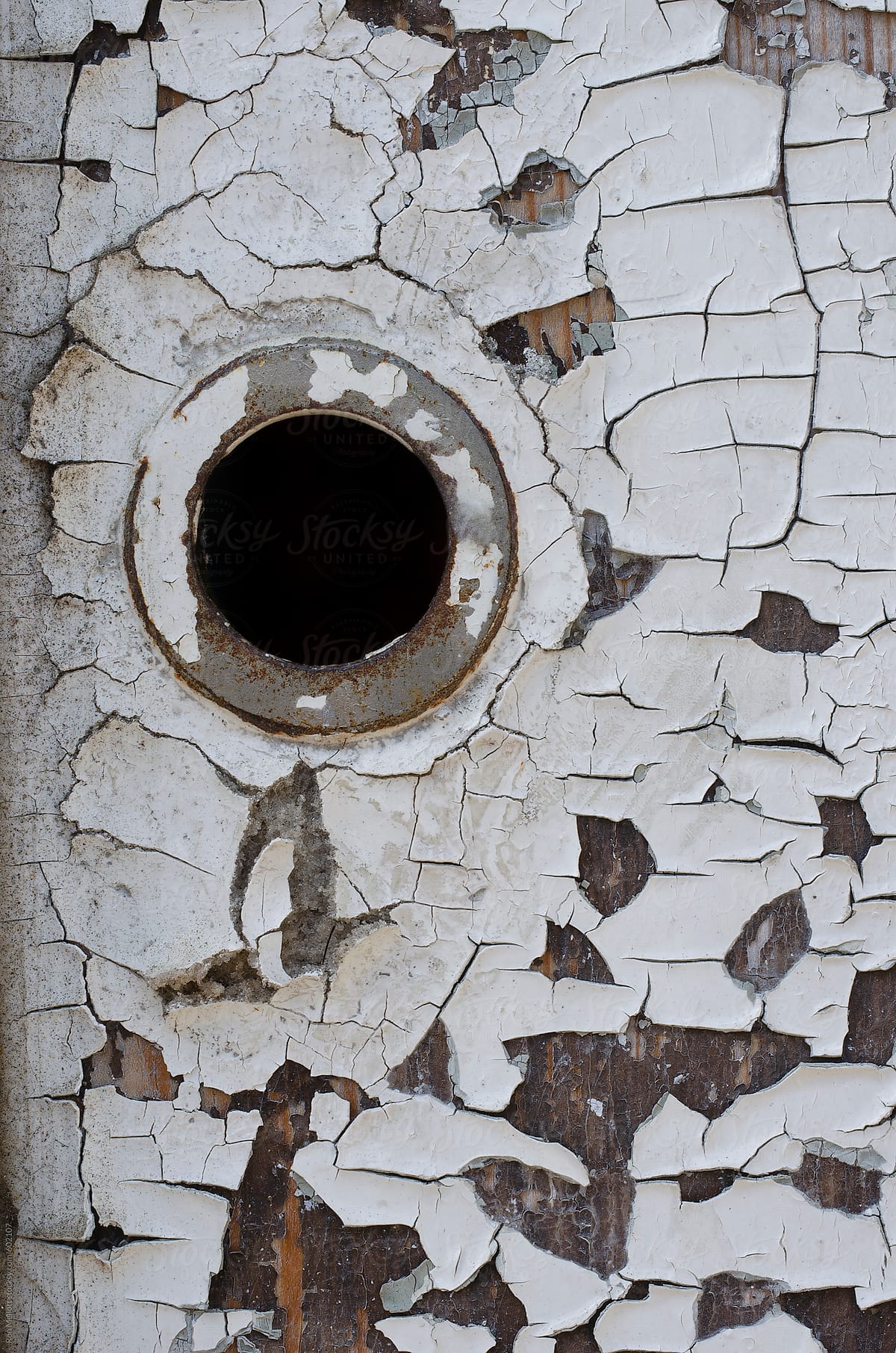 closeup macro macrophotograph deteriorating paint exterior wood door doorknob hole