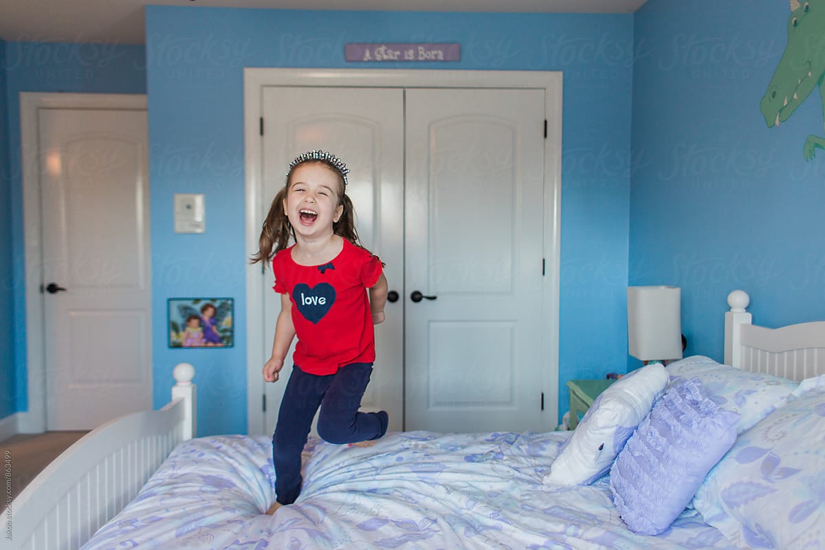 Cute Young Girl Jumping On Her Bed By Stocksy Contributor Jakob 