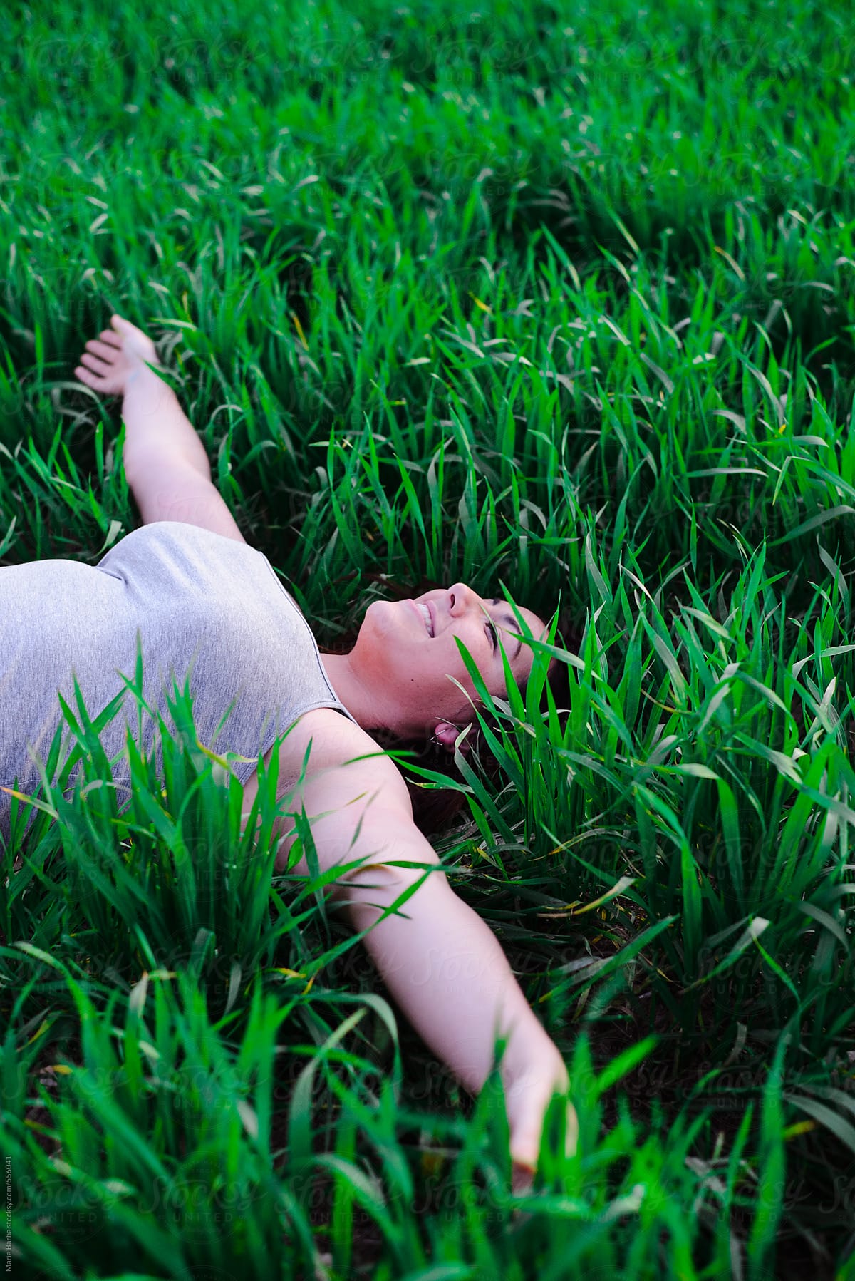 Natural Spanish Woman Lying On The Grass By Stocksy Contributor María Barba Stocksy