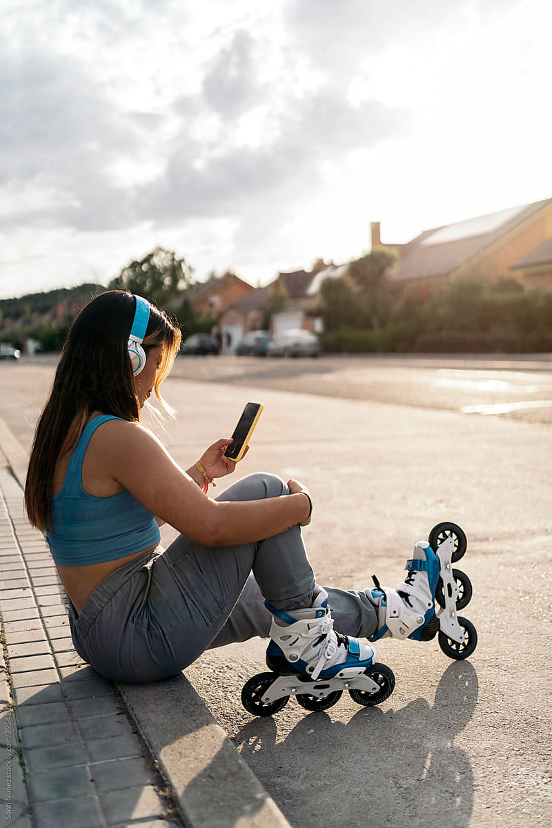 Young Skater Woman Using Phone