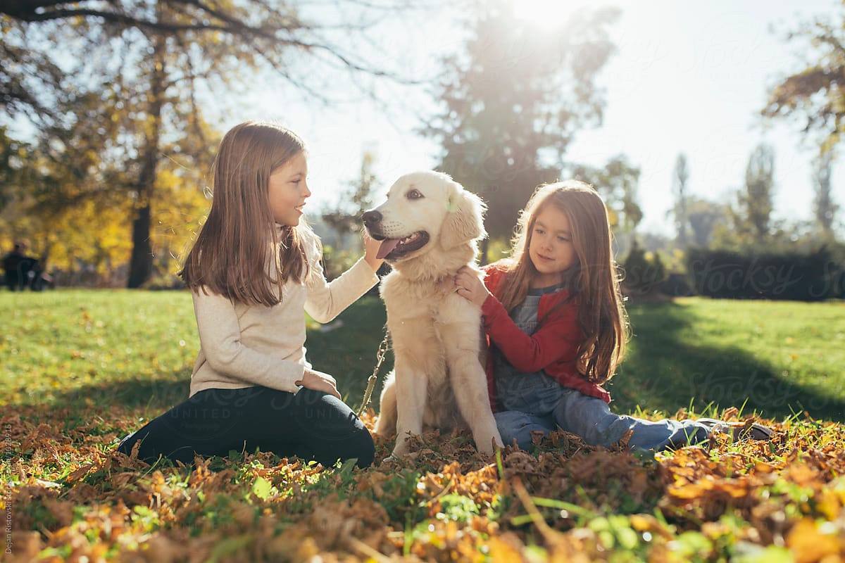 Two girls and a Golden Retriever.