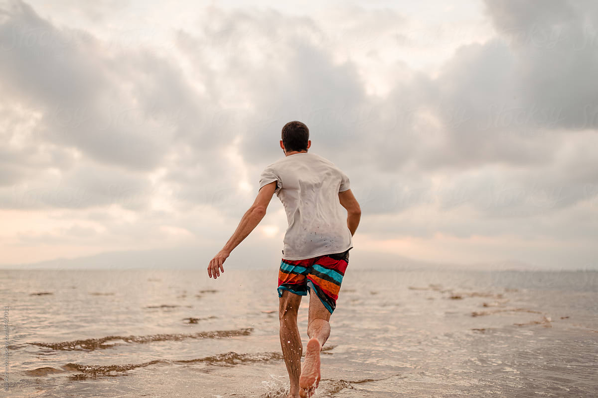 Running man on tropical empty beach