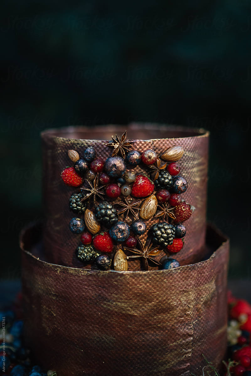 Copper color chocolate cake decorated with fruits