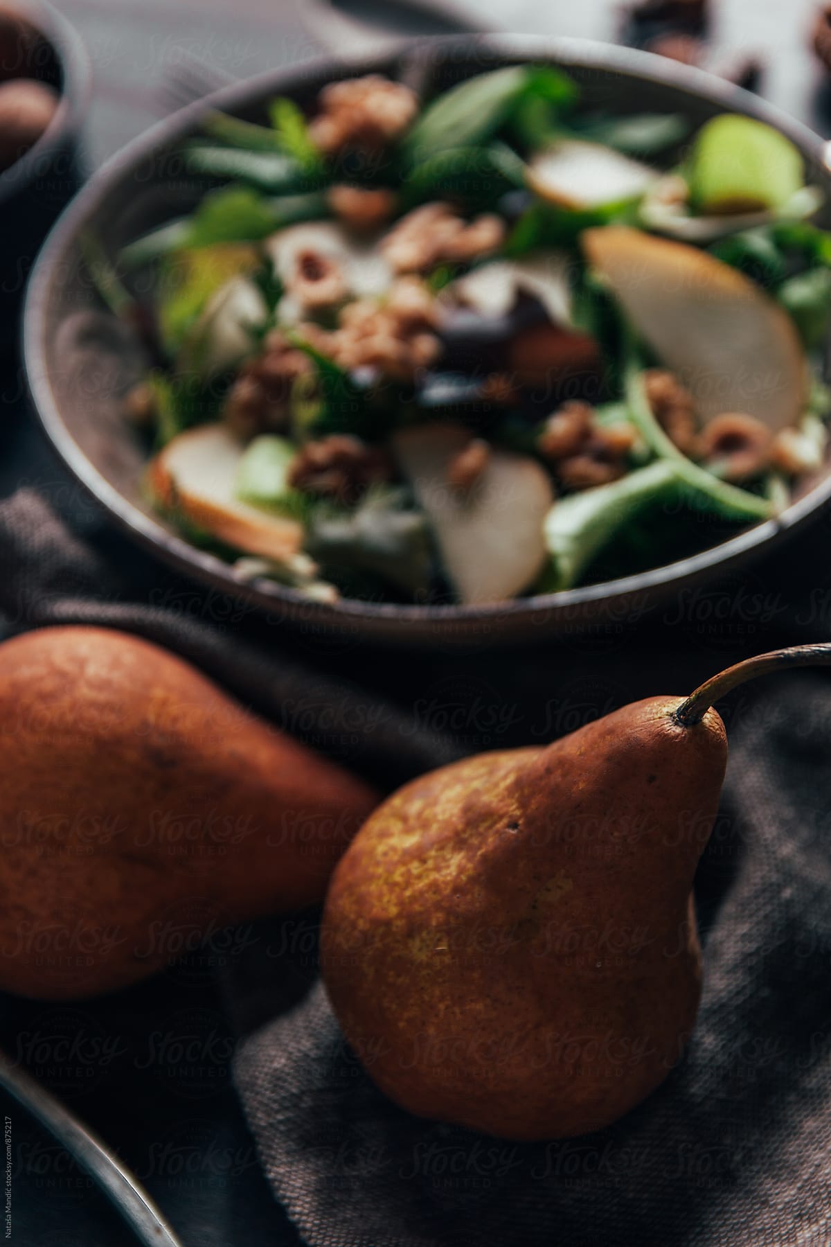 Delicious salad with pear, walnuts and hazelnuts