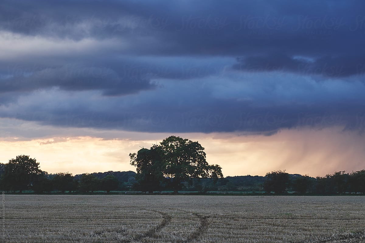 Dark stormy sky over rural landscape at sunset. Norfolk, UK.