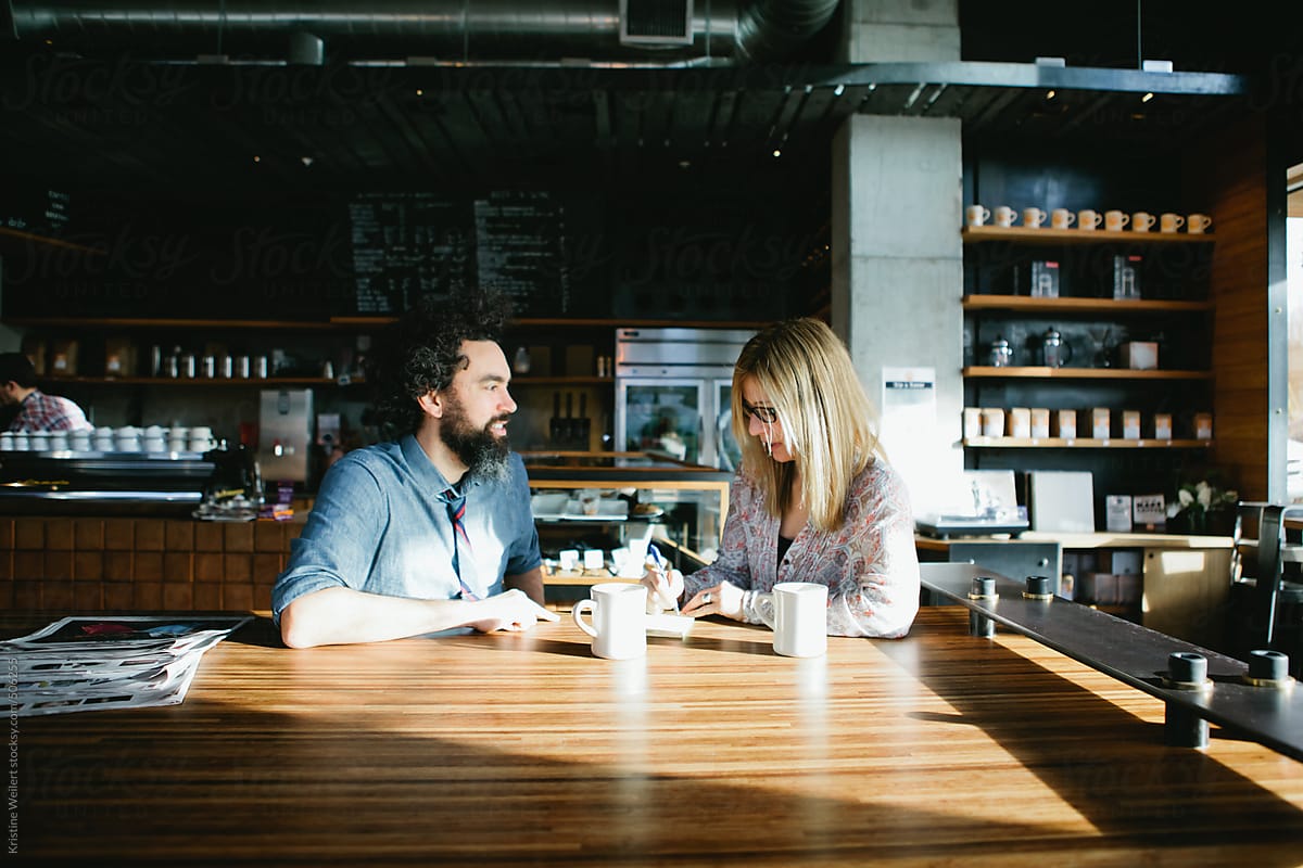 Man and woman having a conversation over coffee in a cafe