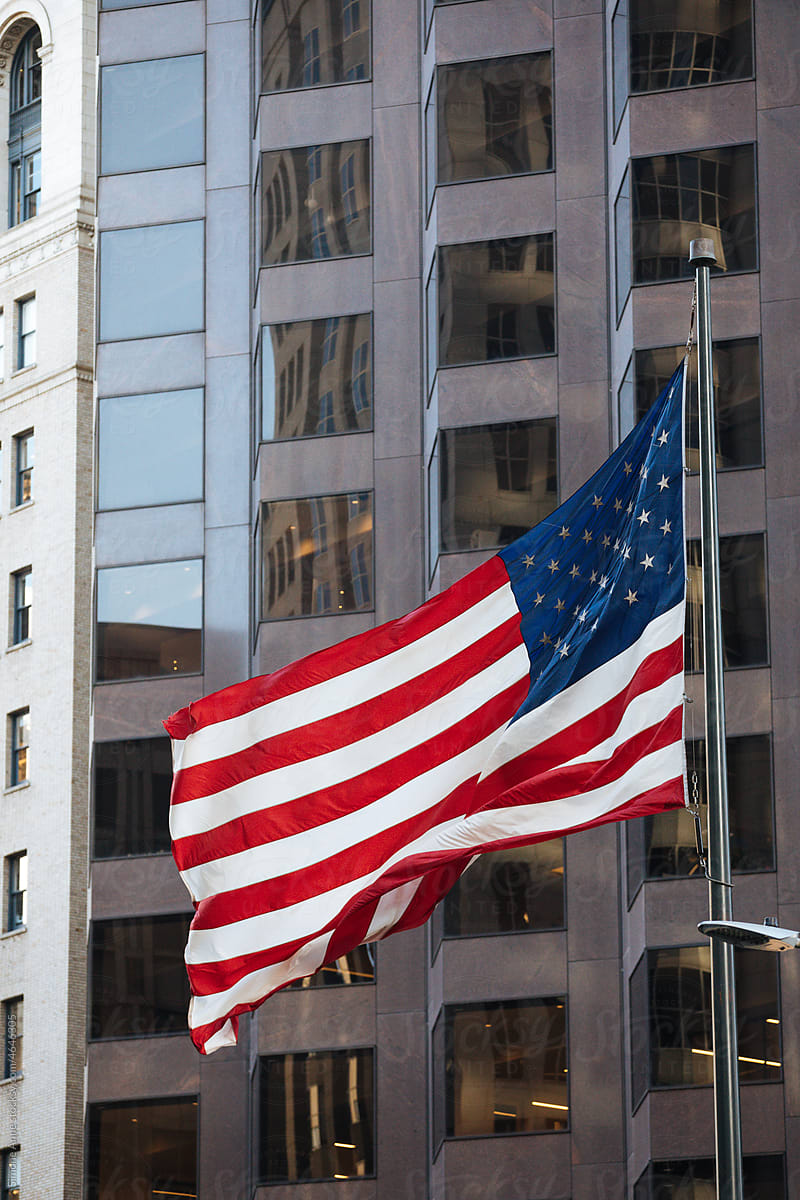 American flag flapping in front of office building