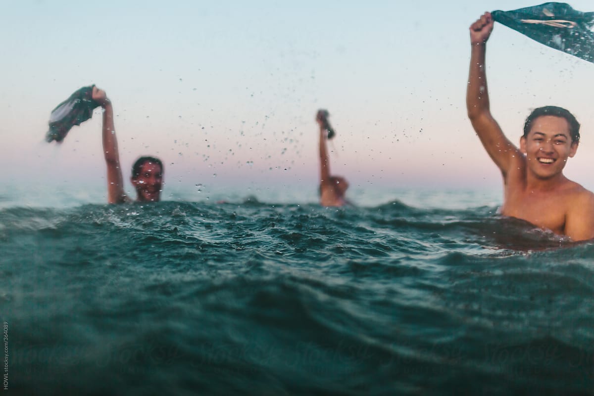 Three friends skinny dip in the Maryland ocean.