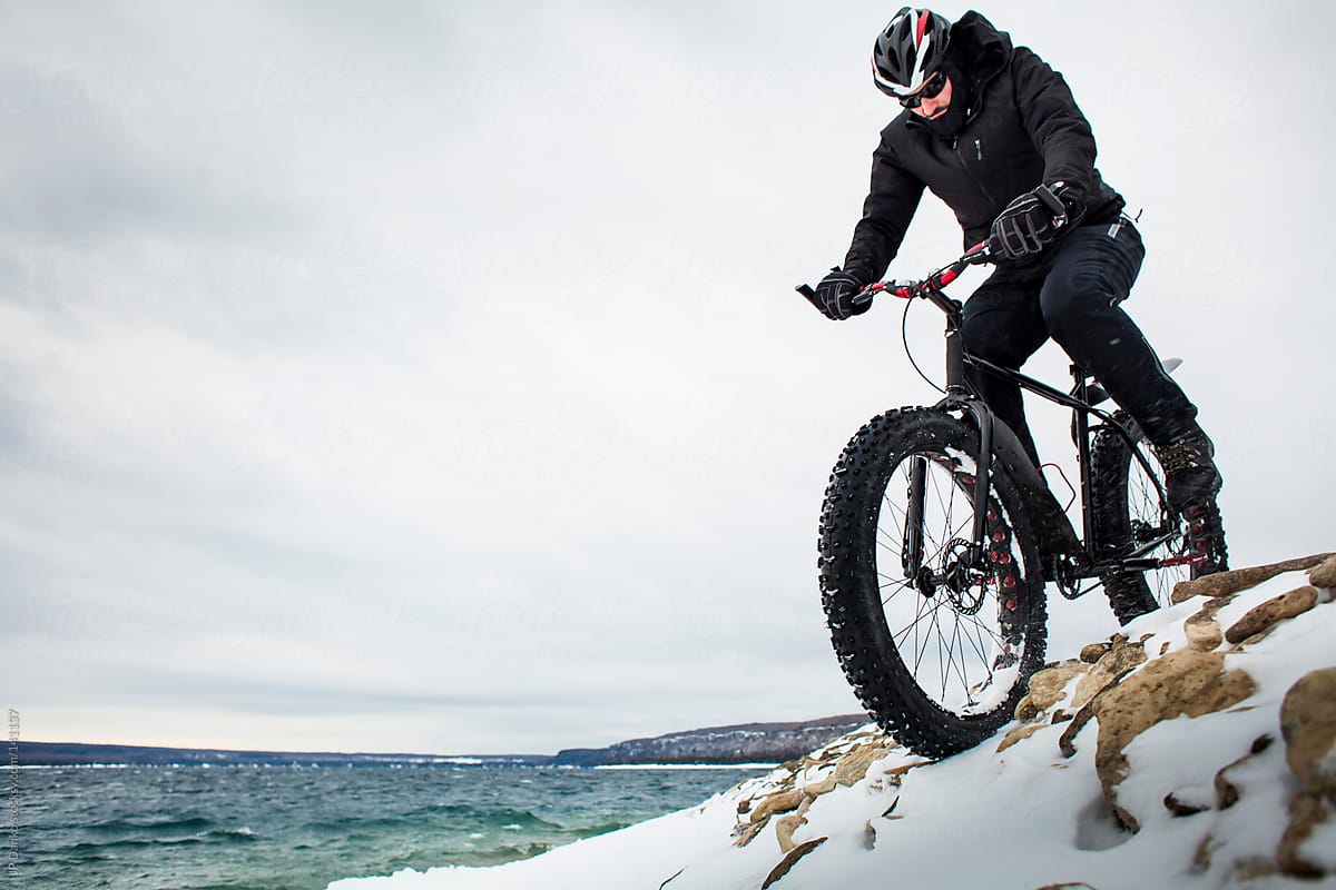 Extreme Sport Winter Mountain Bike Rider on Fat Bike In Snow