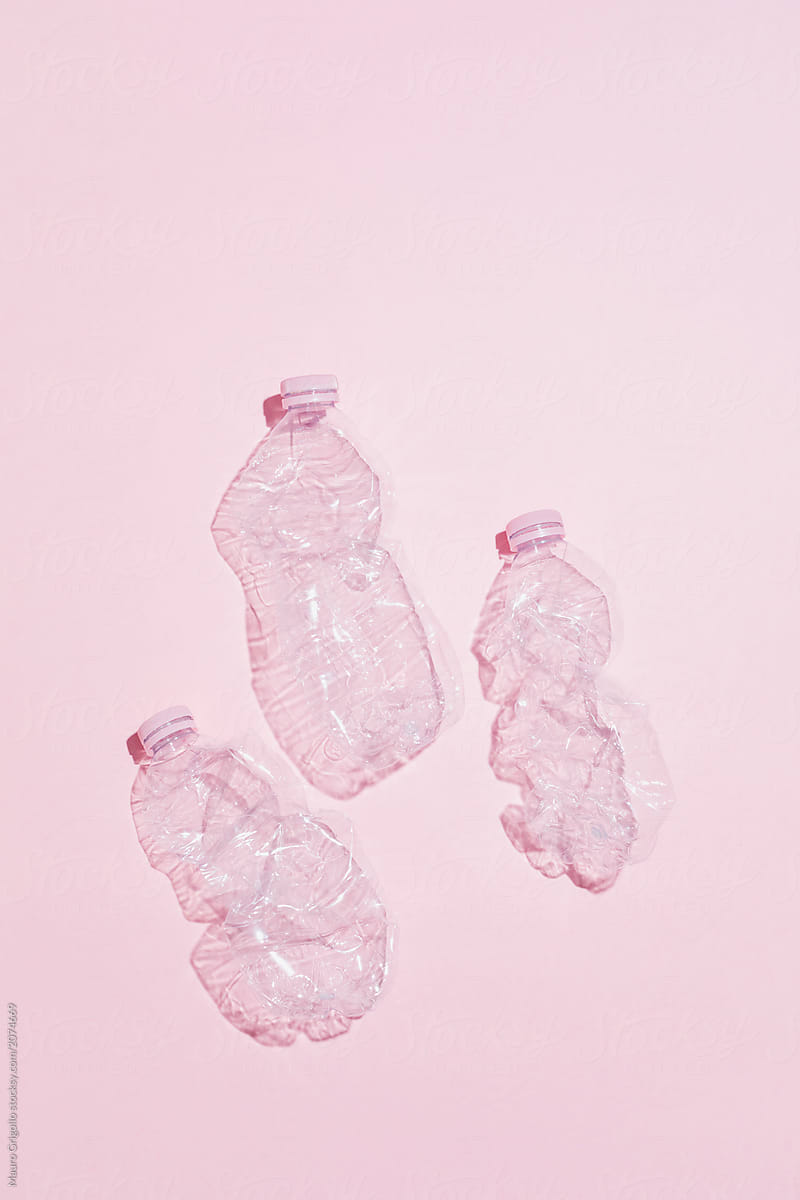 Plastic bottles on pink background