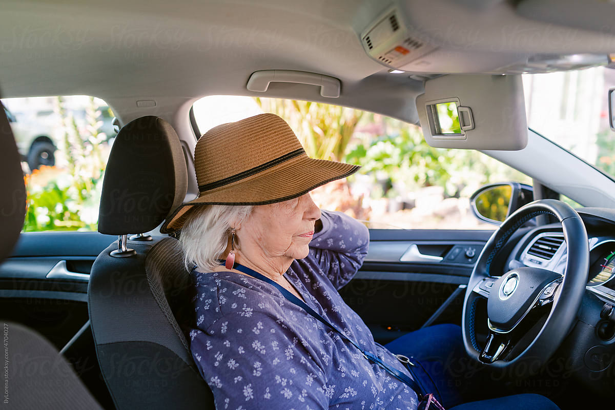 Senior woman inside her car